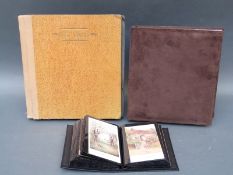 Two albums of gallery and art museum postcards and an album of early 20thC greeting cards