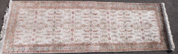A 20th Century Turkish runner, green ground with foliate design, approximately 244 cm x 67cm.