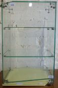 A glass counter top display cabinet with Ovaltine impression on glass and two shelves (H60 x W37 x