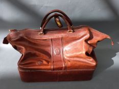 A tan leather rectangular travel bag marked Ceancarel, approx. 50cm long.