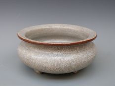 A Chinese crackle glazed bowl on tripod feet,