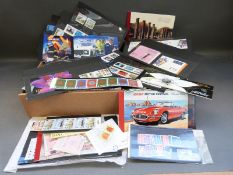 A box and a box file containing mint modern postage stamps from the Isle of Man, Alderney,