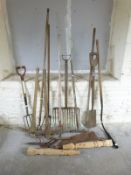 A quantity of vintage garden tools including peat cutter etc