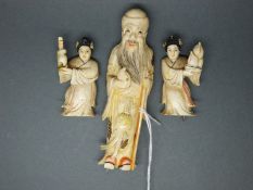 Three ivory figures, two women and an elder,
