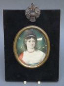A 19thC portrait miniature on ivory of a lady with ringlets in her hair, max diameter 6.
