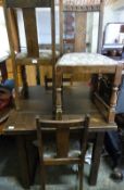 An oak draw leaf table and four upholstered chairs