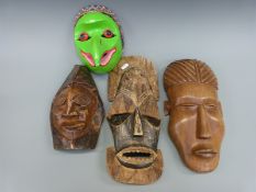 Three various African wooden masks and a Jatayu bird mask