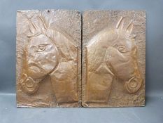 A pair of hammered copper wall plaques of horses