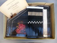 A German autoharp with 12 chords in lacquered finish in original box with instruction book,