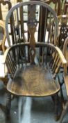 A 19thC elm seated Windsor chair (see lot 1551 for matching dining chairs)