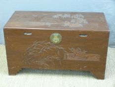 A carved oriental chest with camphor lining and decoration of a fishing scene (H56 x L103 x D50)