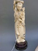 A 19thC Chinese carved ivory okimono of a robed lady,