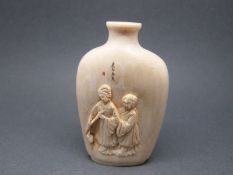 An ivory scent bottle with carved figural decoration to one side and engraved mountainous scene to