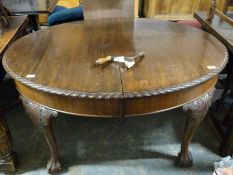 A Victorian mahogany dining table raised on ball and claw feet with additional leaf and winder (H73