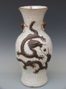 A Chinese crackle glazed vase with relief modelled dragon decoration,