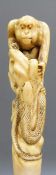 A 19thC Japanese Meiji period ivory handle/carving depicting two monkeys and snakes, length 10.