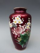 A Japanese cloisonne vase with decoration of prunus and chrysanthemums and silver mounts 23cm tall