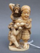 A Japanese Meiji period carved ivory signed okimono of a figure with monkeys, 8.