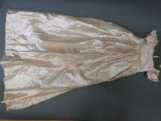 A collection of late 19th/early 20thC child's clothing to include ivory silk coats,