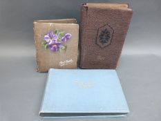 An album of French postcards together with two albums of other overseas postcards,