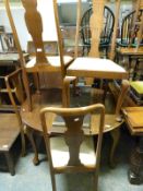 A walnut table with extra leaf and winder and five chairs (H70 X W110 x max L147cm)