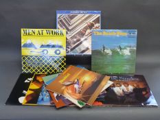 A small collection of 14 LPs including The Beatles, The Pirates, Joni Mitchell and Abba.