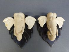 A pair of ivory elephant busts on rosewood plaques circa 1920's