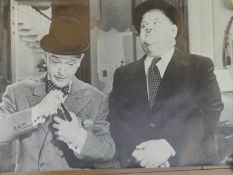 A collection of posters including Humphrey Bogart, Laurel & Hardy, Salvador Dali, Smirnoff Vodka,