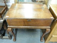 A 19thC oak table/chest on stand with decorative brass hinges,