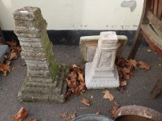 A stone bird bath and a similar pedestal
