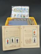 A large collection of cigarette cards to include horse racing, British costumes, footballers,