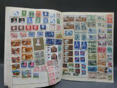 A box of loose stamps and albums