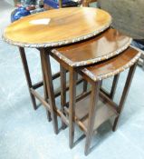 An oval mahogany nest of tables