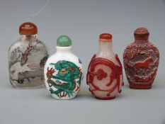 Four Chinese scent bottles comprising ceramic with green dragon decoration,