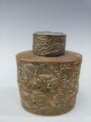 A Japanese bronzed tea caddy with embossed dragon decoration 11cm tall