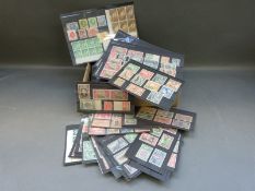 A box containing a quantity of mint GB Commonwealth stamps on stock cards