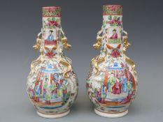 A pair of 19thC Chinese Canton vases, with applied chilong decoration to shoulder, 24.