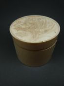 A Japanese Meiji period ivory powder pot with carved lid depicting peonies and irises, 5.5cm x 7.