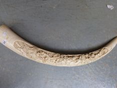 A Chinese resin moulding in the form of a realistic carved ivory tusk.