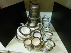 A Victorian Staffordshire part tea set with cobalt and gilt grape and vine border,