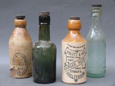 A quantity of stone and glass bottles to include named example including Stroud Brewery, Niblett's,