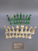 A 19thC Indian carved and stained ivory chess set, height of king 11cm.