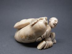 A Japanese carved ivory snuff bottle in the form of a man carrying a giant gourd or fruit, 5.