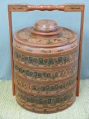 A Burmese lacquered multi layered food carrier with elephant and figural decoration (77cm tall)