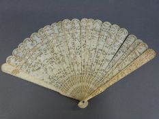 A 19thC Cantonese carved ivory brise fan decorated with dragons, figures and foliage, 18cm long.