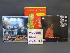 A box of jazz including MJQ, Dave Brubeck and Johnny Hodges LPs, 78s and 45s.