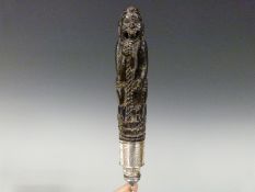 A Chinese carved horn figural handle in the form of an emaciated immortal with white metal mount