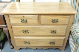 A satin walnut chest of drawers with two over two graduated drawers and shaped apron (H84 x W103 x