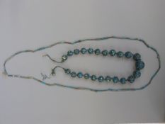 An ancient Egyptian faience beaded necklace and another similar,