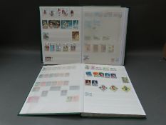 A collection of stamps from Central and South America in four Lighthouse stockbooks,